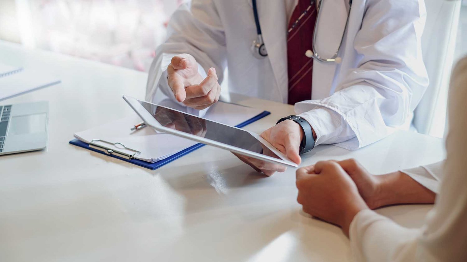 medico con tablet durante consulta